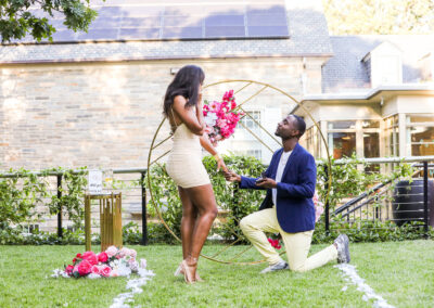 A man proposes to his girlfriend in the garden at an event venue in Washington DC.